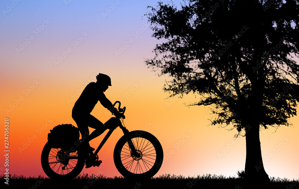 Fototapeta premium Silhouette man and bike relaxing on blurry sunrise sky background.