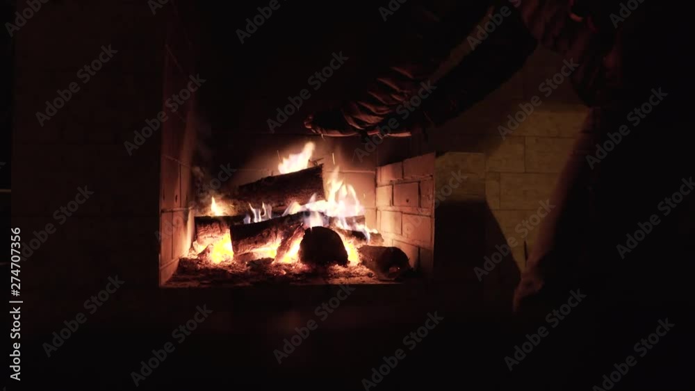 LOCKED OFF view of person placing wood inside outdoor Fireplace LOCKED OFF view of person placing wood inside outdoor Fireplace