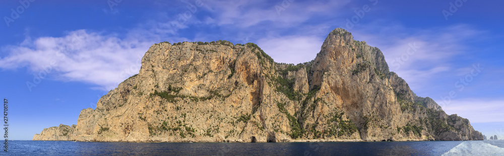 Landscapes of the island of Capri from the sea.View of the coastline with the rocky shores and sea caves. Landscapes of the island of Capri from the sea.View of the coastline with the rocky shores and sea caves.
