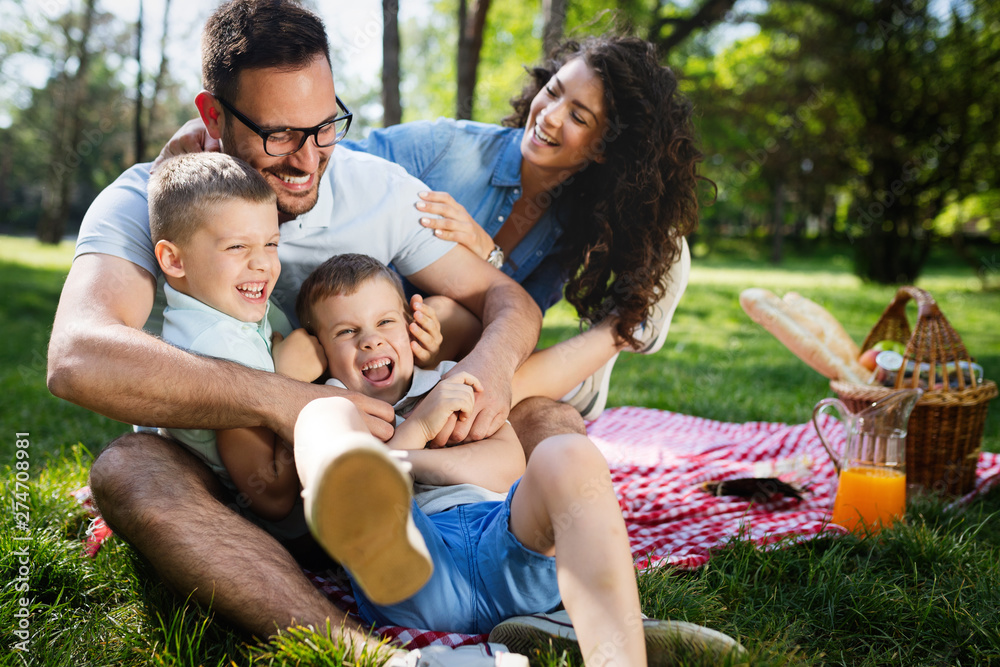 Fototapeta premium Cheerful happy family picnicking on a beautiful day