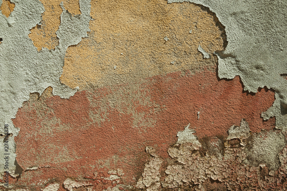 Worn wall with plaster covered by peeled paint Worn wall with plaster covered by peeled paint