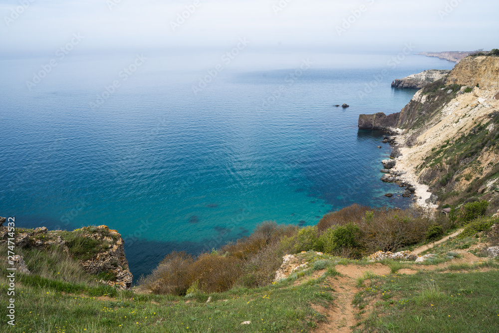 Mediterranean coast with high cliffs and rough sea Mediterranean coast with high cliffs and rough sea