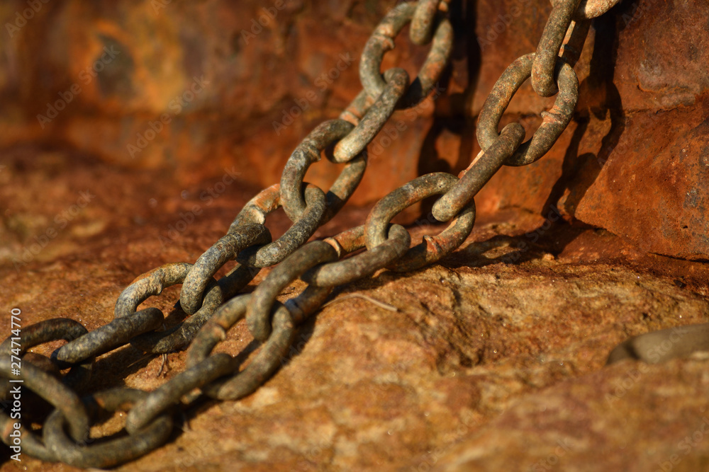 Old rusty chain on sandstone