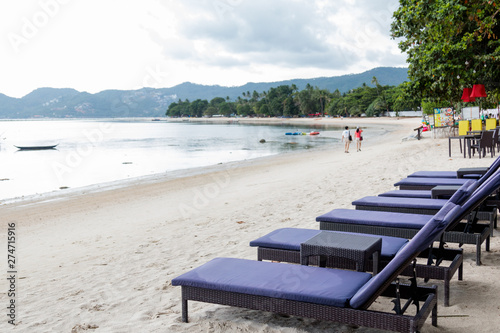 Fototapeta Naklejka Na Ścianę i Meble -  beach chairs on white sand beach and sea view at Chaweng Beach, Thailand.