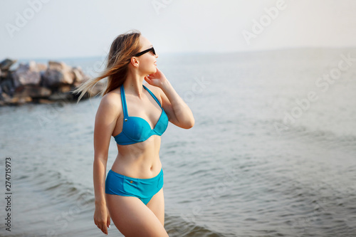 Young cute girl on the beach.