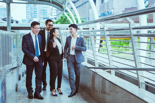 Businessman and businesswoman discussing work while walking, vintage tone effect.happy business concept. photo