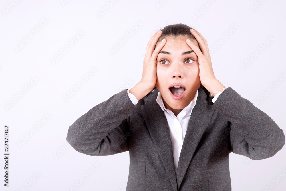 young woman standing over grey grunge wall crazy and mad shouting and yelling with aggressive expression and arms raised. Frustration young woman standing over grey grunge wall crazy and mad shouting and yelling with aggressive expression and arms raised. Frustration