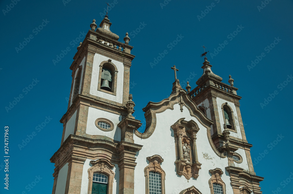 Baroque bell towers from church with whitewashed wall