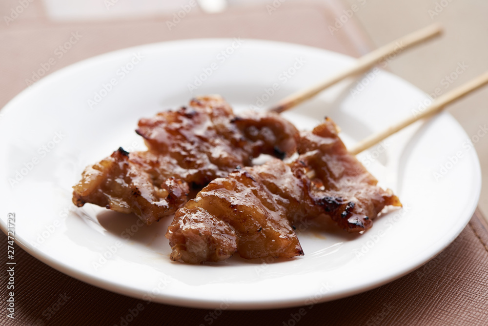 A plate of grilled pork on the table