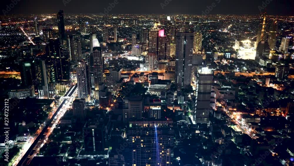 Top aerial view from tower rooftop, road junction traffic skyscrapers and busy evening highways night transition in modern downtown of Bangkok thailand. Top aerial view from tower rooftop, road junction traffic skyscrapers and busy evening highways night transition in modern downtown of Bangkok thailand.