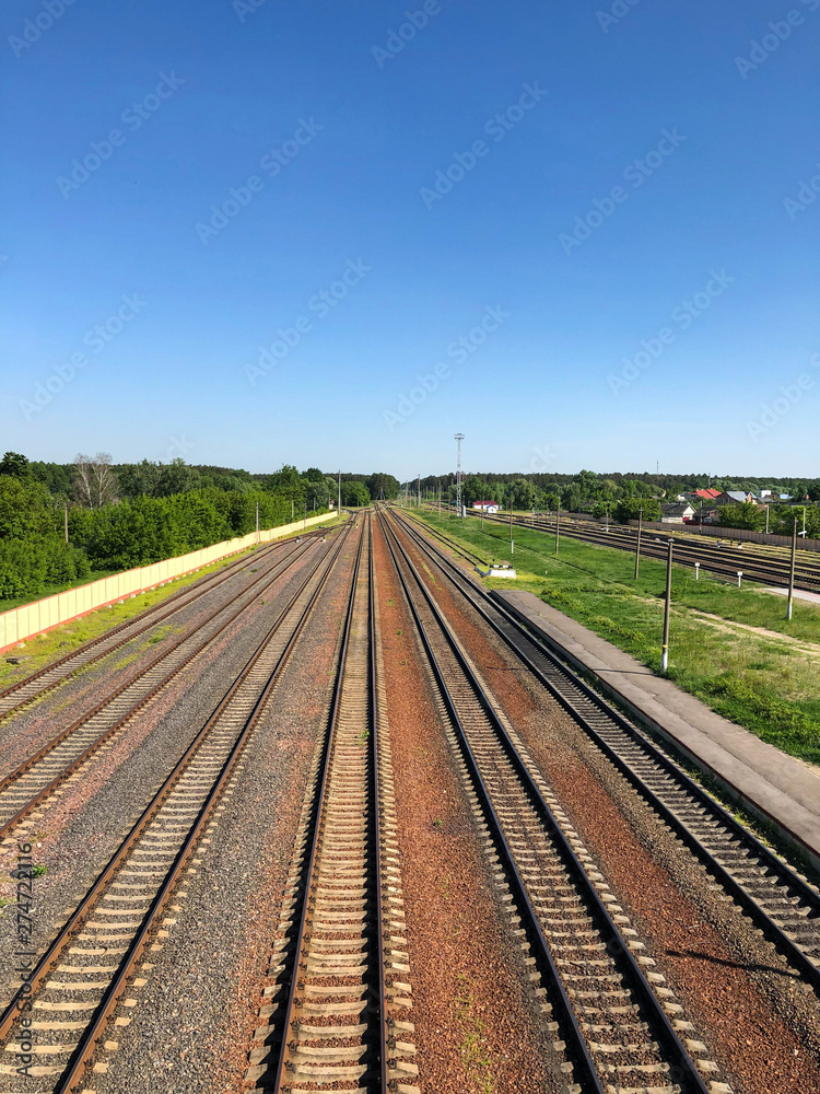 View of the railway going away and the blue sky.