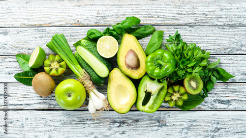 Fototapeta Naklejka Na Ścianę i Meble -  Fresh organic green fruits and vegetables. Avocado, kiwi, onion, lime, parsley. Organic food. Rustic style. Top view. Free space for text.