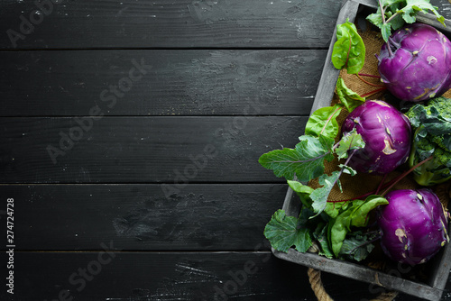 Purple kohlrabi cabbage. On a black background. Top view. Free space for your text. photo