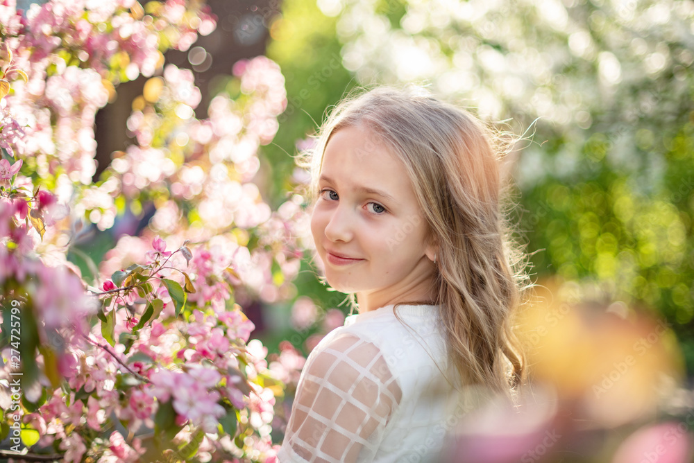 candid portrait of a girl in a blooming apple orchard candid portrait of a girl in a blooming apple orchard