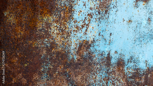Rusty metallic texture. Oxidation of the metal. Grunge, steampunk, rock, vintage. Iron background, brown, red and blue.