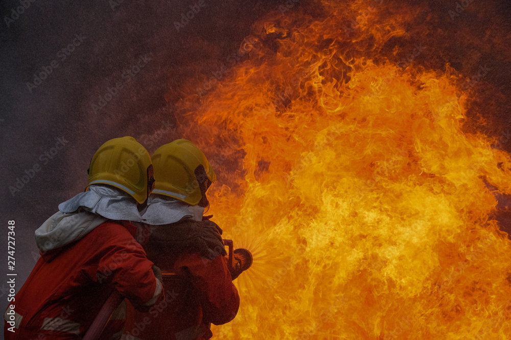Firefighter are using water in fire fighting operation Stock Photo ...