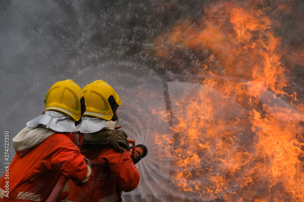 Firefighter are using water in fire fighting operation Firefighter are using water in fire fighting operation