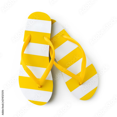 Top view of summer beach yellow striped flip flop isolated on white background sea holiday vacation and travel concept photo