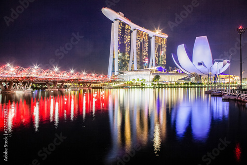 SINGAPORE, SINGAPORE - MARCH 2019: Skyline of Singapore Marina Bay at night with Marina Bay sands and Art Science museum reflecting in a pond after rain. Vibrant night scene