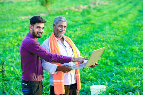 indian agronomist with farmer at field
