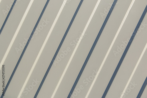 Background. The surface of the white profiled sheet. Roofing material and wall decoration