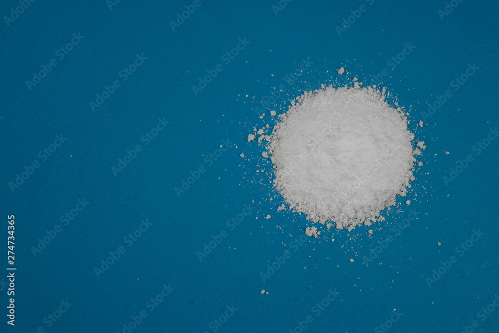 a mountain of white powder on a blue background