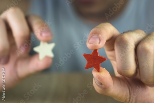 a man holding a red and white star