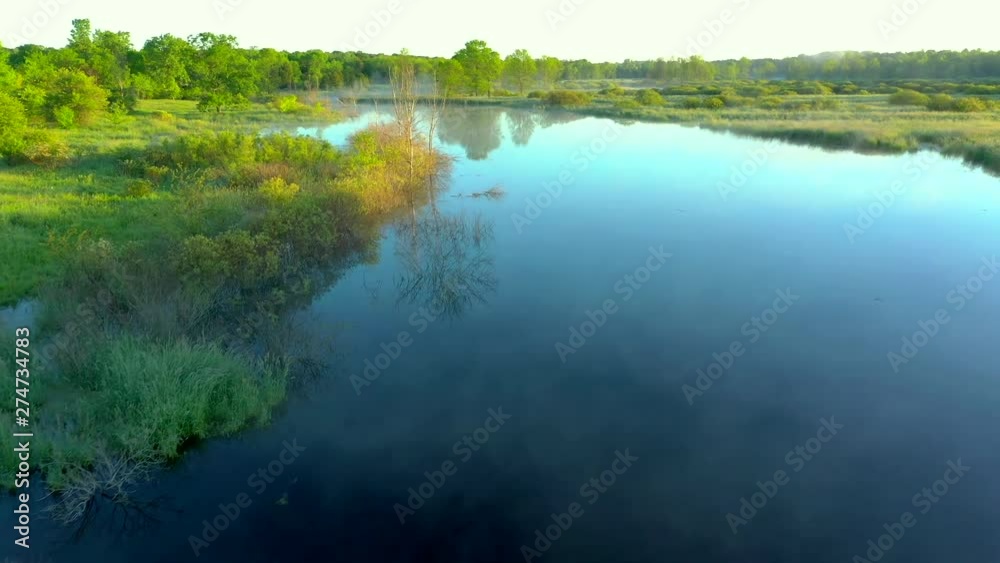 Scenic Wisconsin wilderness landscape with foggy winding river at sunrise, aerial flyover. Scenic Wisconsin wilderness landscape with foggy winding river at sunrise, aerial flyover.
