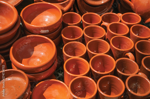 Earthenware cups and bowls made from varnished baked clay