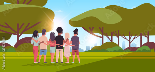 young people group embracing rear view men women hugging friendship day celebration concept friends having fun sunset landscape background full length horizontal