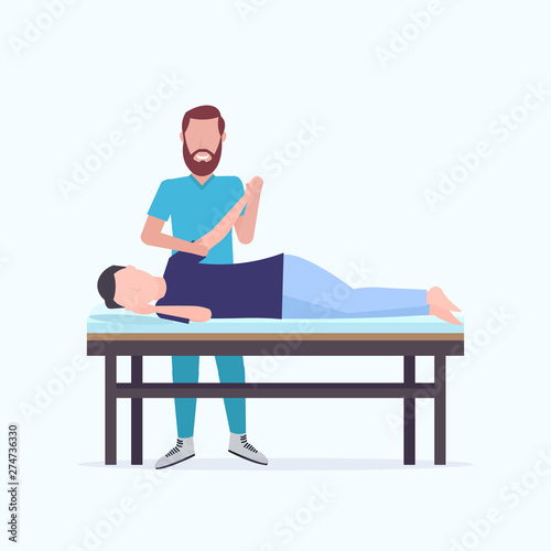 man patient lying on massage table masseur therapist doing healing treatment massaging injured hand manual sport physical therapy rehabilitation concept full length
