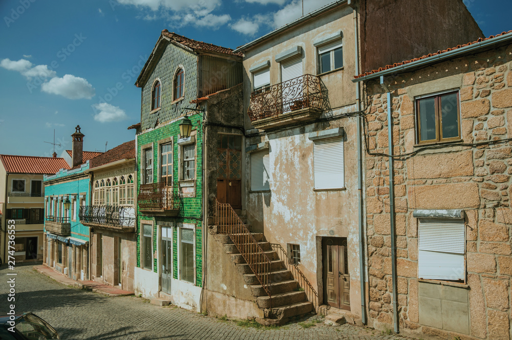 Old houses with worn facade and staircase