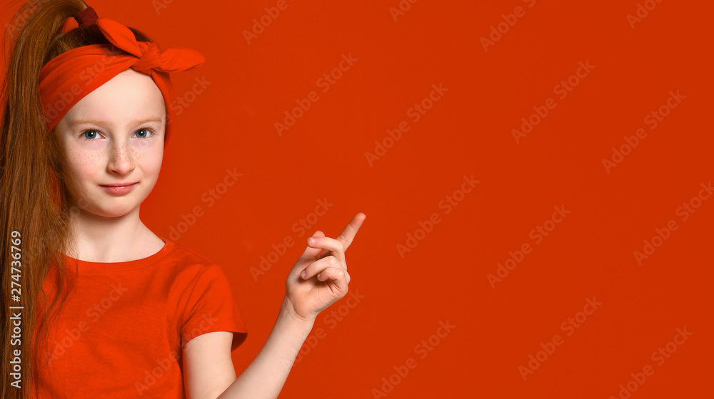 cute little red-haired girl with a bandage on her hair, smiles and places a spot for your advertisement. cute little red-haired girl with a bandage on her hair, smiles and places a spot for your advertisement.
