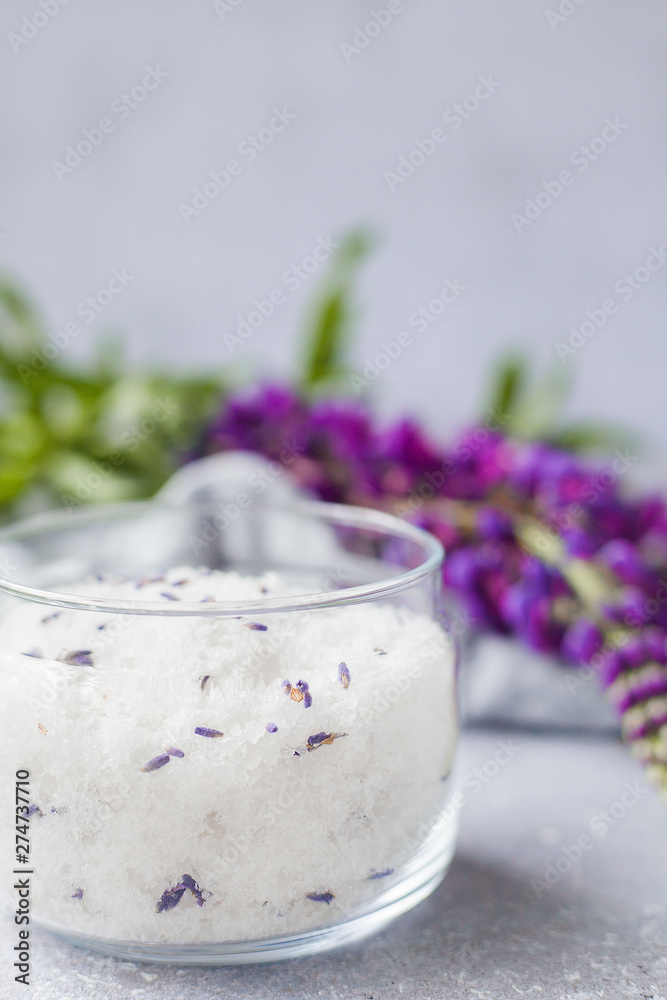 Salt scrub, lavender, Towel on Grey background Salt scrub, lavender, Towel on Grey background