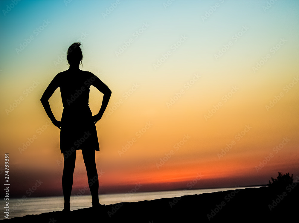 woman posing at sea sunset