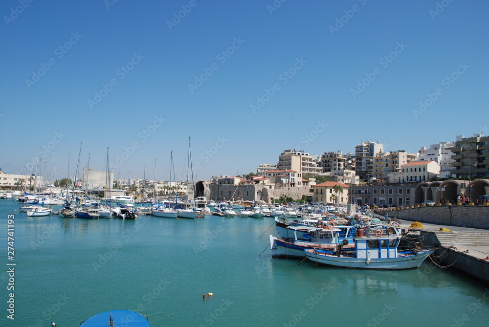Street on the pier with yachts in the resort town of Heraklion, Crete