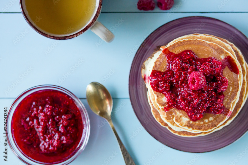 Healthy breakfast,homemade classic pancakes with fresh raspberry jam. top view Healthy breakfast,homemade classic pancakes with fresh raspberry jam. top view