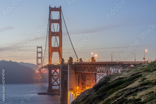 Twilight colors of the Golden Gate Bridge as seen from above Marshall's Beach. San Francisco, California, USA.