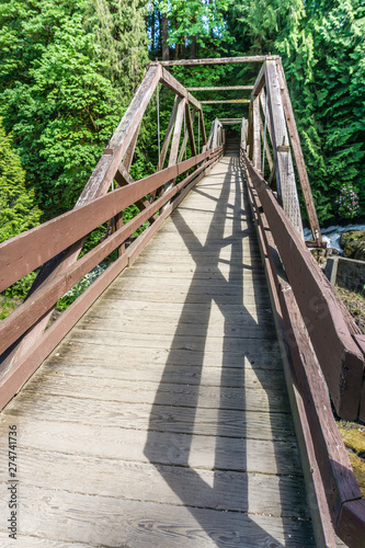 Fototapeta Naklejka Na Ścianę i Meble -  Wooden River Walking Bridge