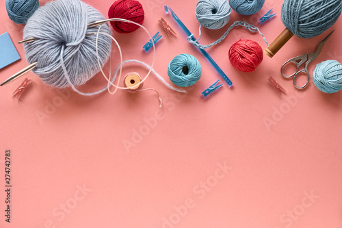 Various wool yarn and knitting needles, creative knitting hobby background
