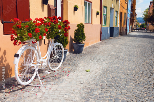 Ornamental bicycle with flowers on it on the streets of downtown Sibiu in Romania