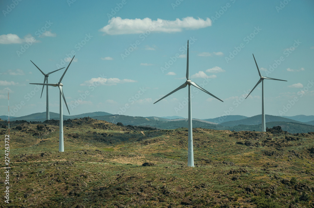 Several wind turbines over hilly landscape Several wind turbines over hilly landscape