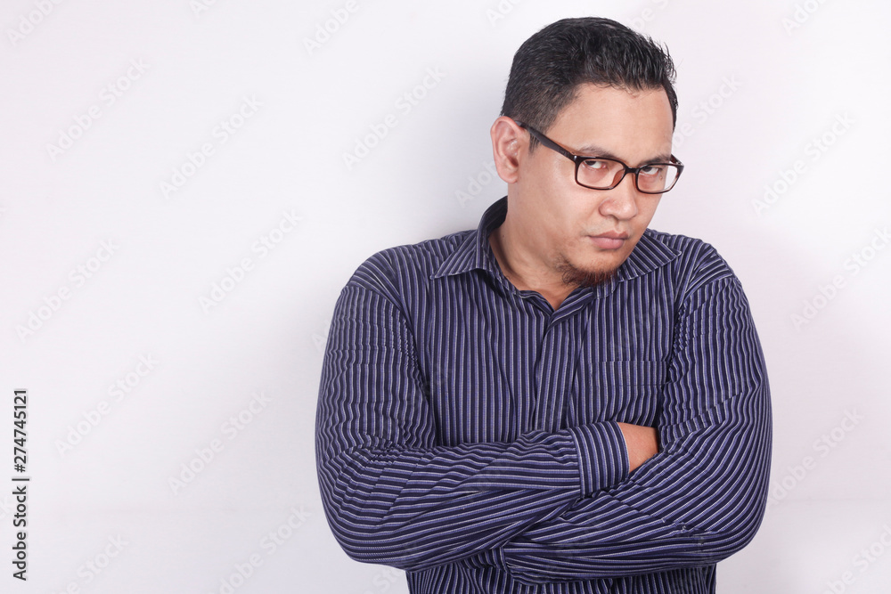 Cynical Asian businessman looking to camera with anger Cynical Asian businessman looking to camera with anger