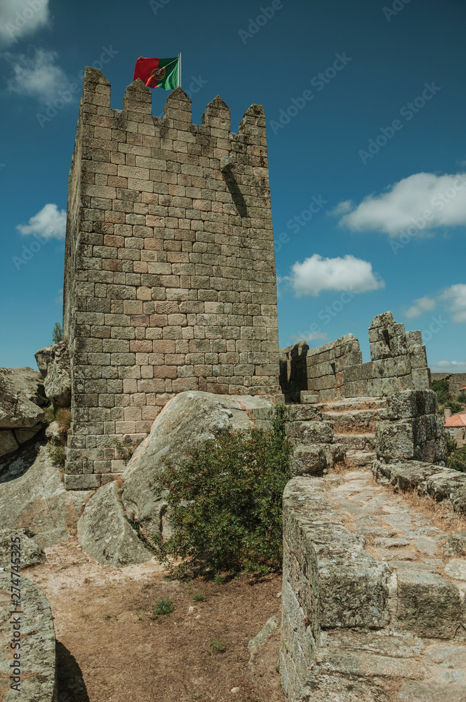 Square tower on top of rocky hill in a castle