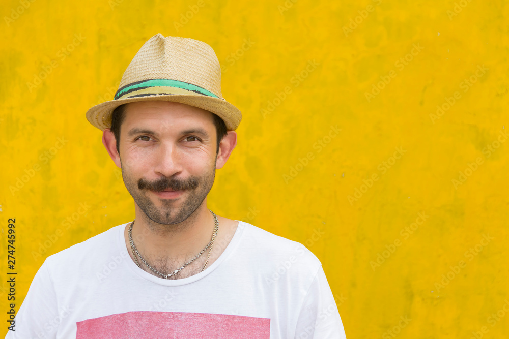 a young man with a mustache is smiling on an old yellow background a young man with a mustache is smiling on an old yellow background