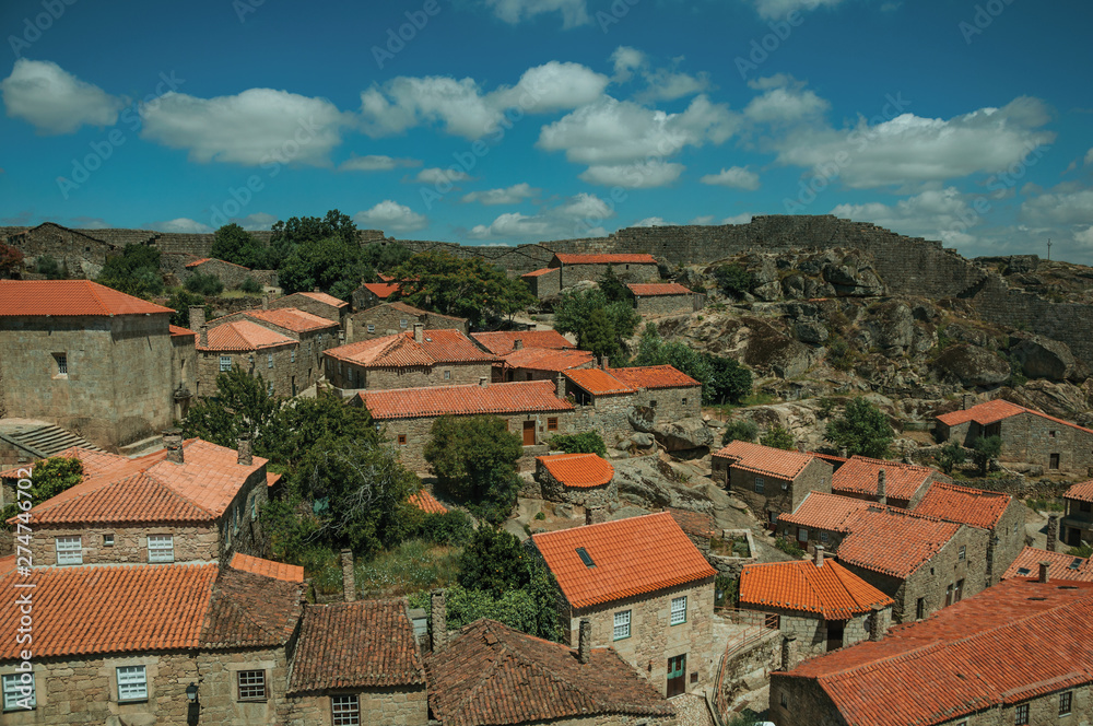 Rooftops of stone houses and large wall