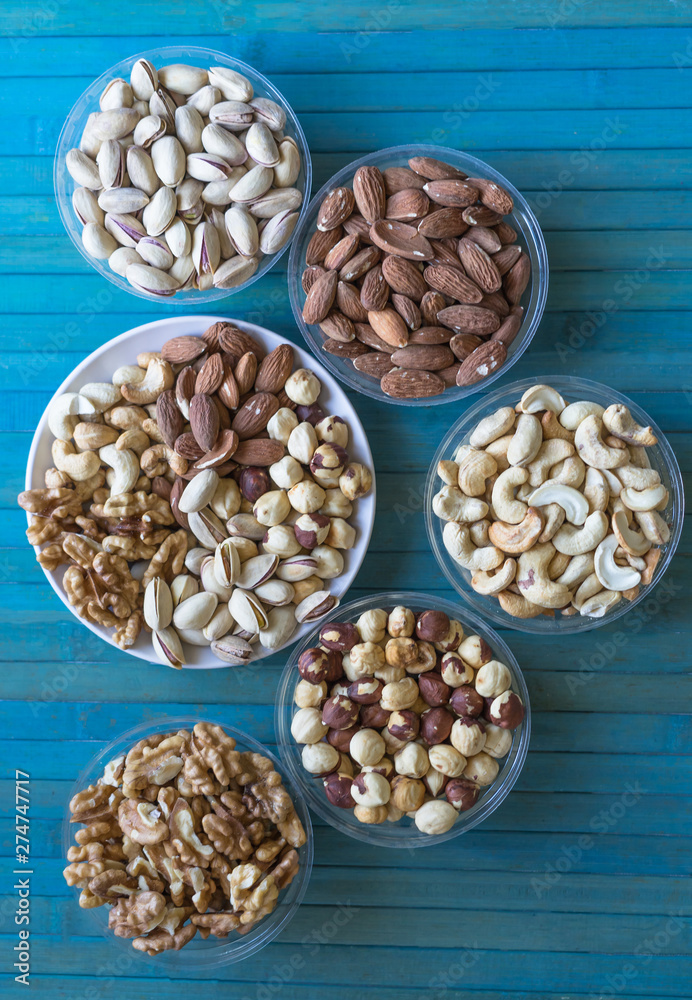 Healthy food. Nuts mix assortment on texture top view. Collection of different legumes for background image close up nuts, pistachios, almond, cashew nuts, peanut, walnut. image Healthy food. Nuts mix assortment on texture top view. Collection of different legumes for background image close up nuts, pistachios, almond, cashew nuts, peanut, walnut. image