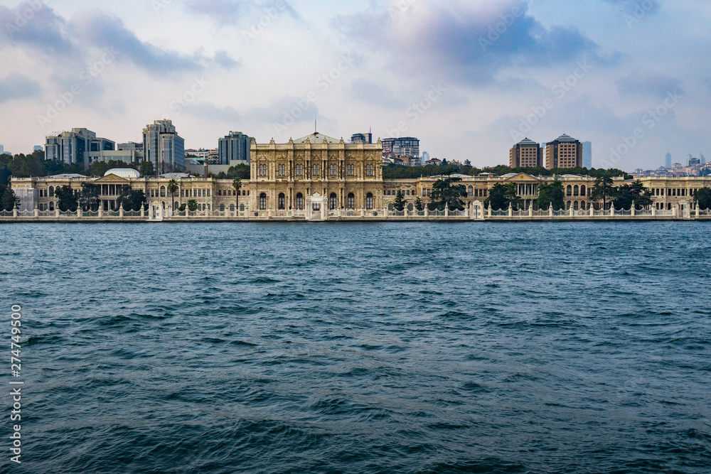 Dolmabahce palace seen from a ferry boat cruising the Bosphorus strait, Istanbul, Turkey Dolmabahce palace seen from a ferry boat cruising the Bosphorus strait, Istanbul, Turkey
