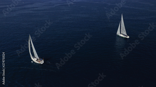 Aerial drone photo of sail boat cruising the deep blue Aegean sea, Greece