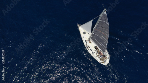 Aerial photo of sail boat cruising open ocean deep blue sea photo